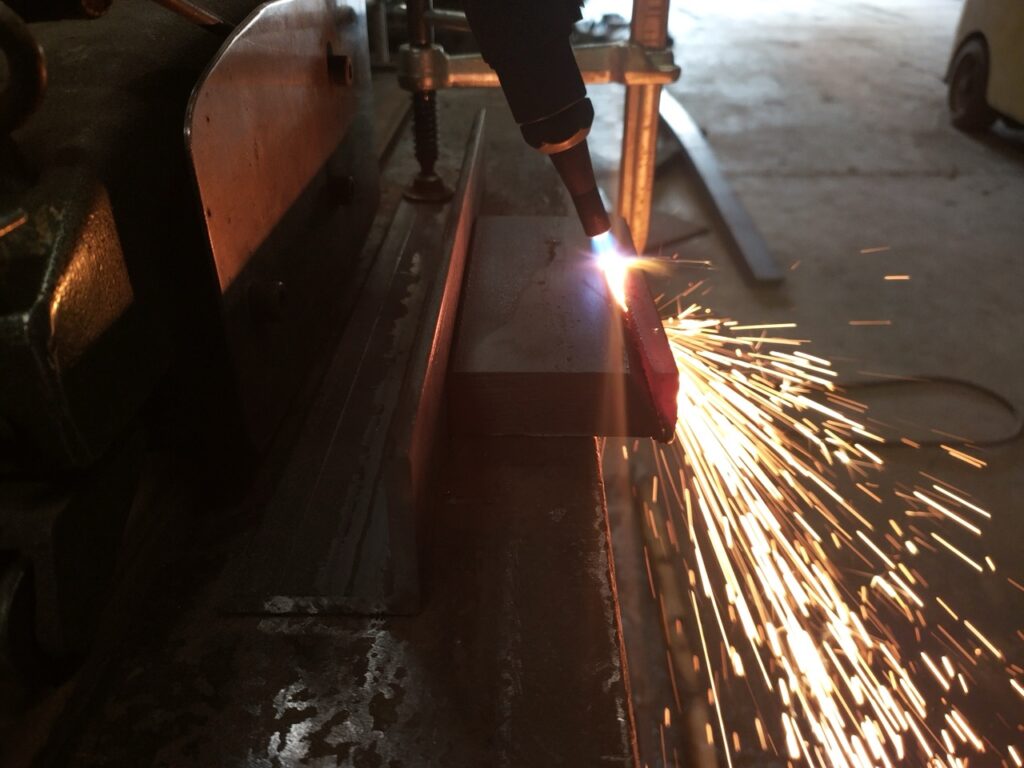 Sparks flying from materials being welded in a workshop