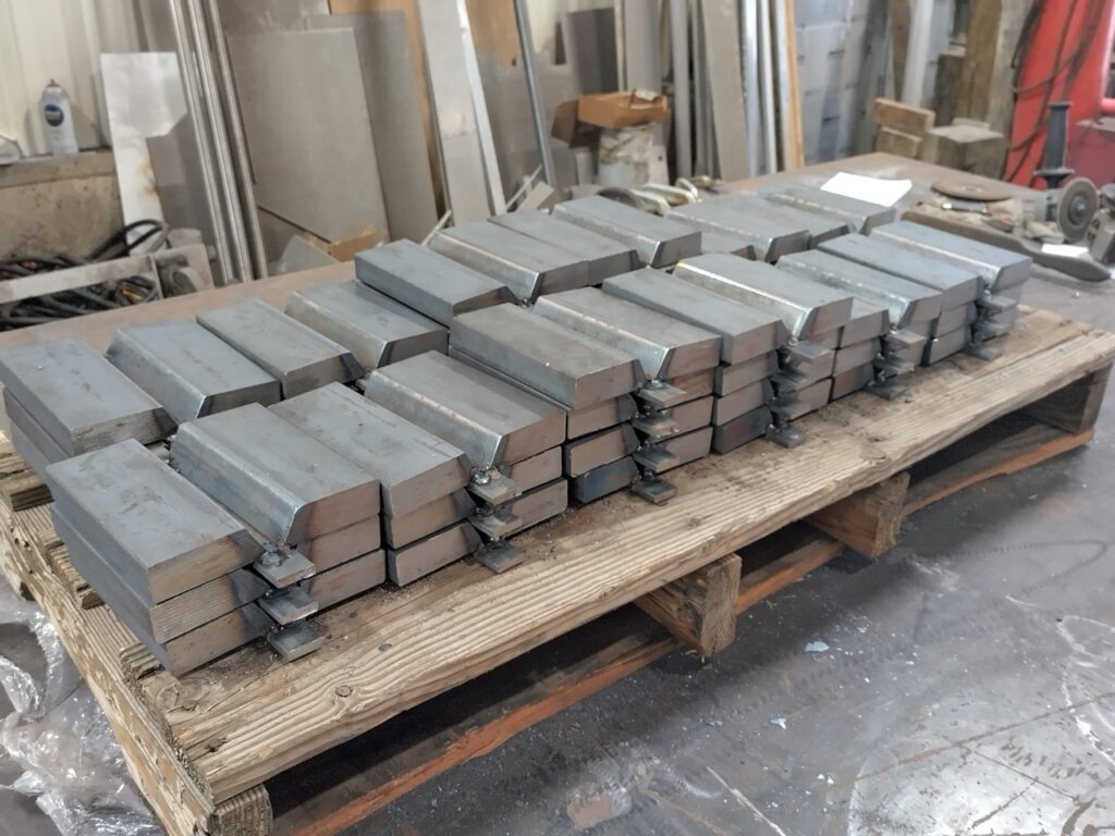 Raw materials of metal on a pallet of wood in shop