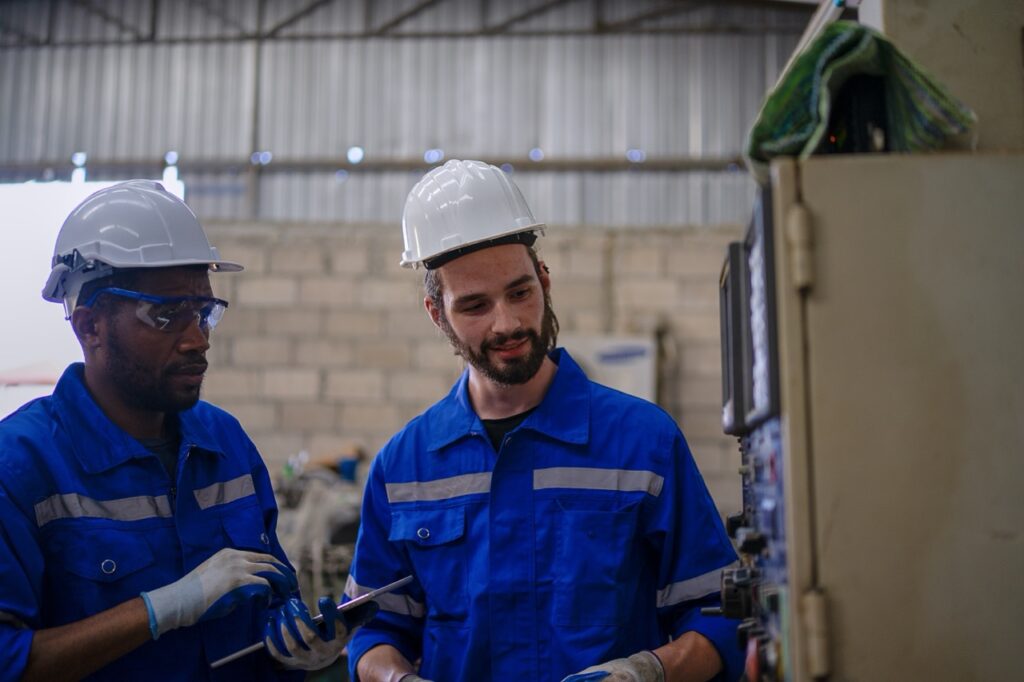 Men wearing blue uniforms and white hardhats